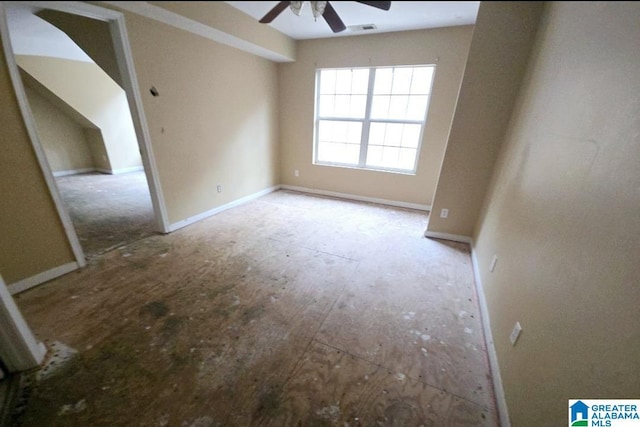 spare room with a ceiling fan, visible vents, and baseboards