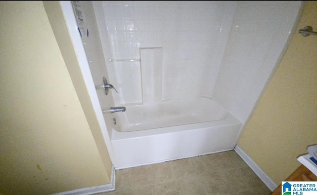 bathroom with shower / bath combination and baseboards