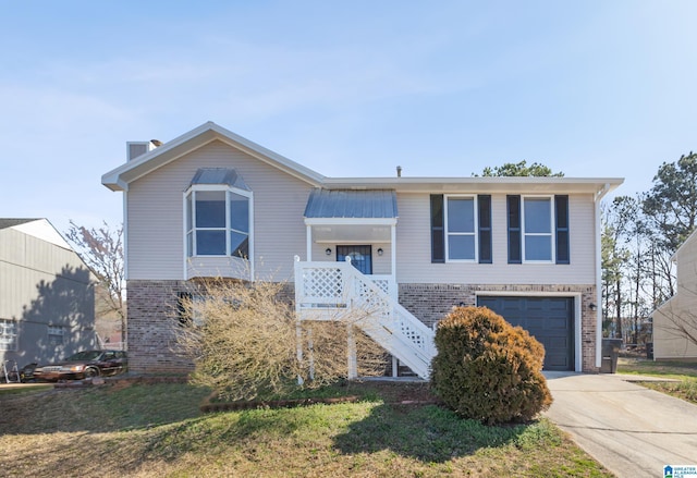 view of front of house featuring driveway, brick siding, stairway, and an attached garage