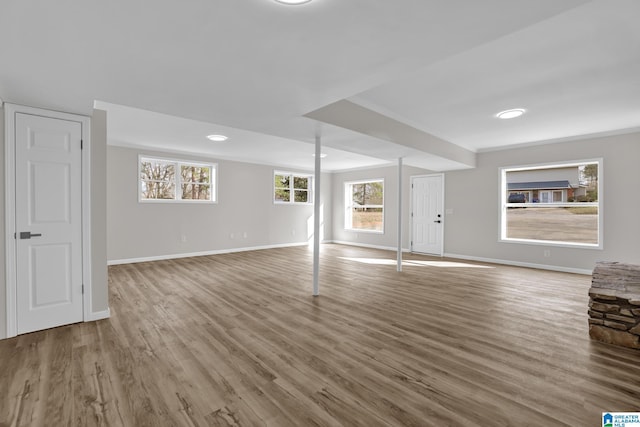 basement featuring wood finished floors and baseboards