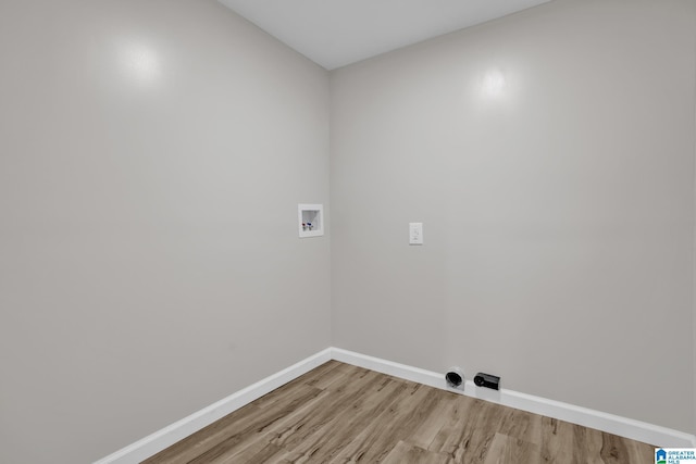 clothes washing area featuring laundry area, hookup for a washing machine, baseboards, and light wood finished floors