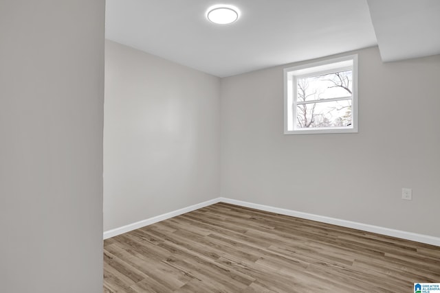 unfurnished room featuring wood finished floors and baseboards