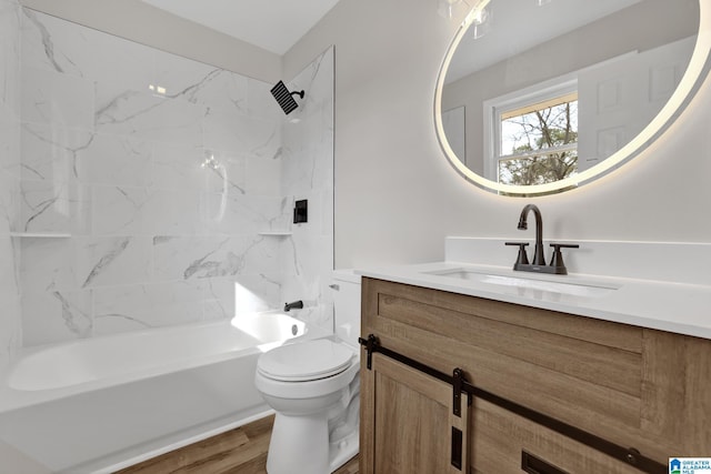 full bathroom featuring bathtub / shower combination, vanity, toilet, and wood finished floors