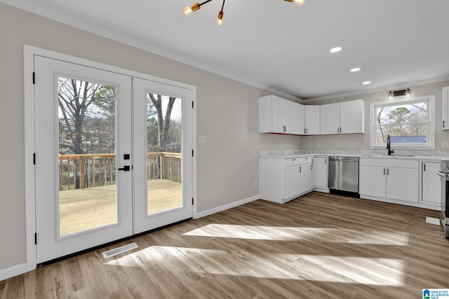 kitchen with a sink, visible vents, ornamental molding, french doors, and dishwasher