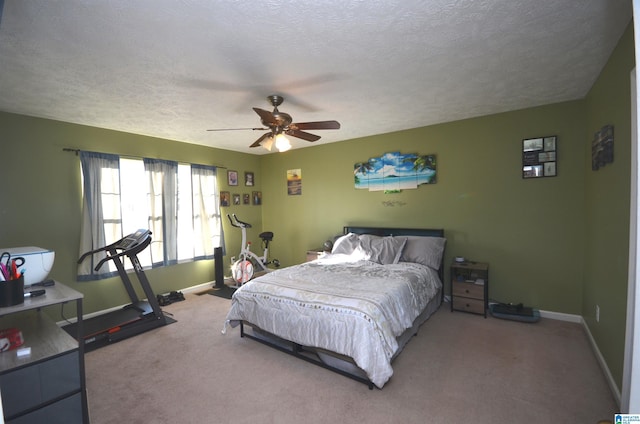 carpeted bedroom with a textured ceiling, ceiling fan, and baseboards