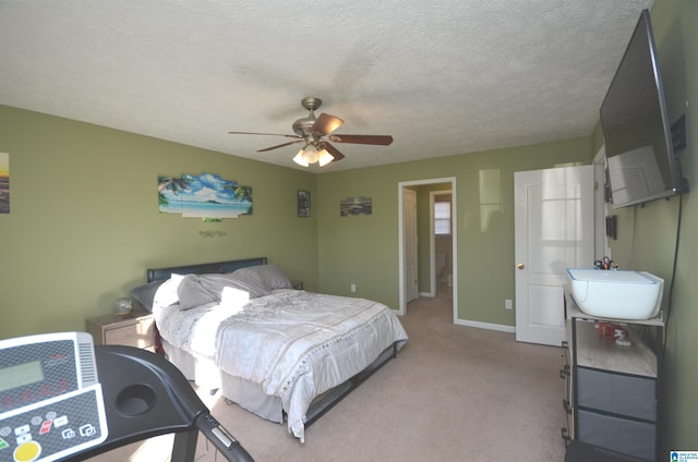 bedroom with light carpet, a ceiling fan, baseboards, and a textured ceiling