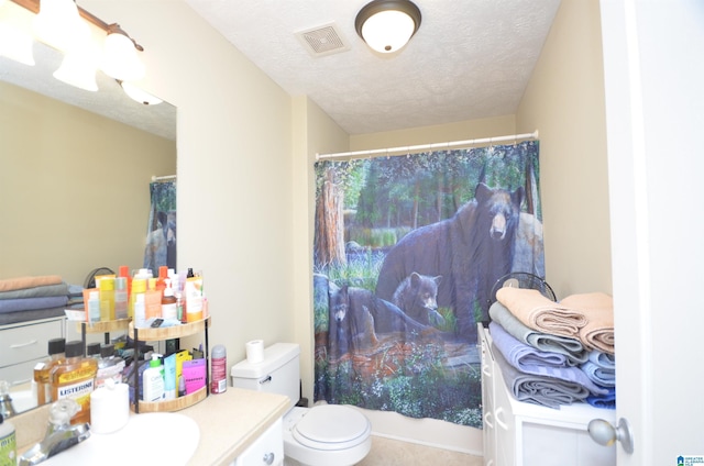 full bath with a textured ceiling, toilet, vanity, and visible vents