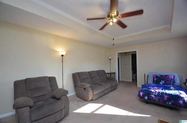 living area featuring carpet floors, a tray ceiling, crown molding, and baseboards