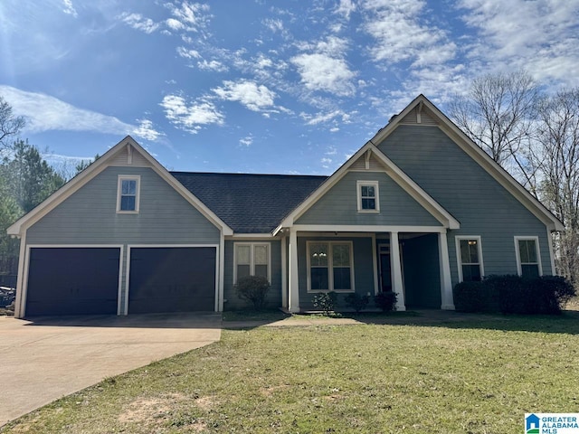 craftsman-style house with driveway, a garage, and a front yard