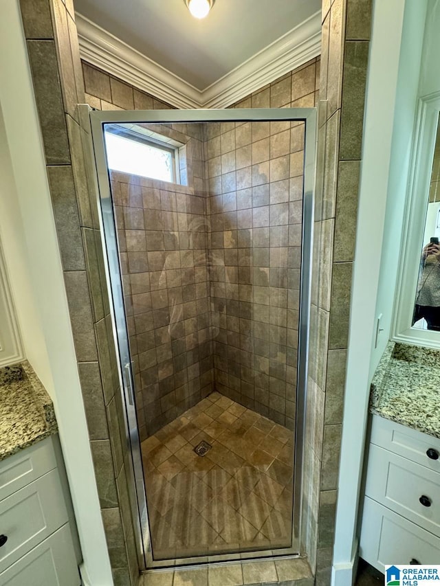 full bathroom featuring a shower stall, ornamental molding, and vanity