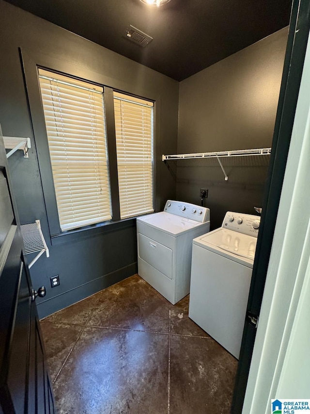 laundry room with laundry area, washer and clothes dryer, and visible vents