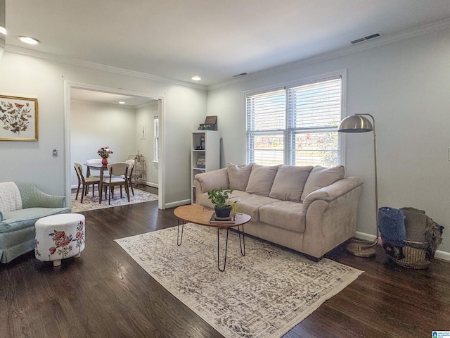 living room featuring baseboards, visible vents, dark wood finished floors, ornamental molding, and recessed lighting