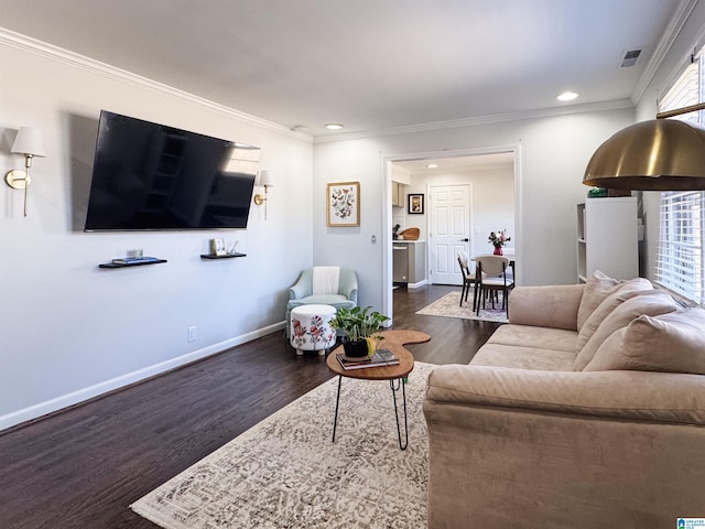 living area featuring crown molding, baseboards, and wood finished floors