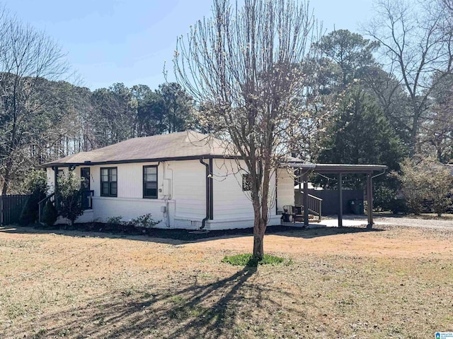 view of front of home featuring a carport, brick siding, and a front lawn