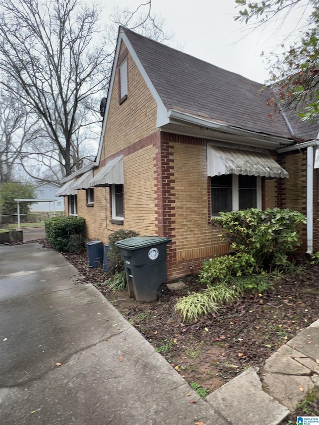 view of property exterior with brick siding