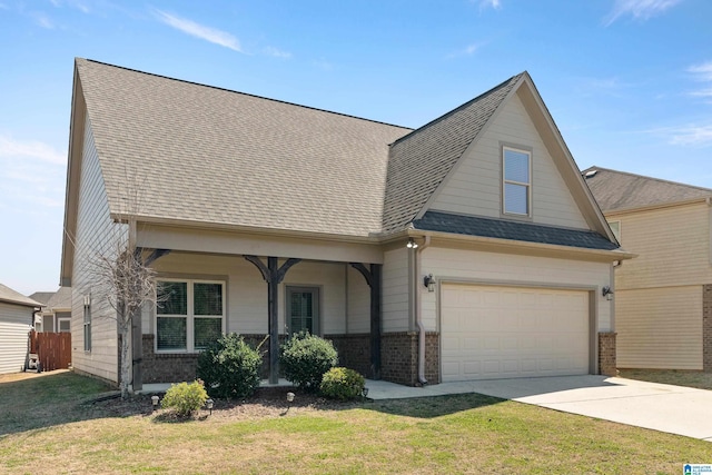 view of front of house with concrete driveway, brick siding, a front yard, and a shingled roof