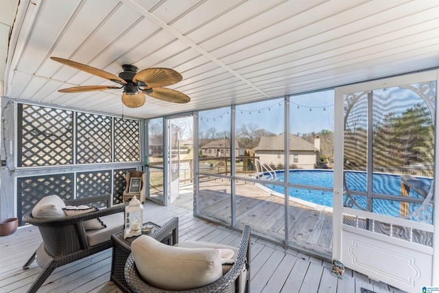 sunroom featuring ceiling fan