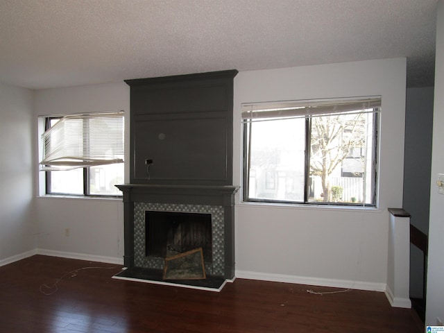 3830 Windhover Dr Unit 1, Vestavia Hills, AL 35216 - unfurnished living room with a tiled fireplace, baseboards, and wood finished floors