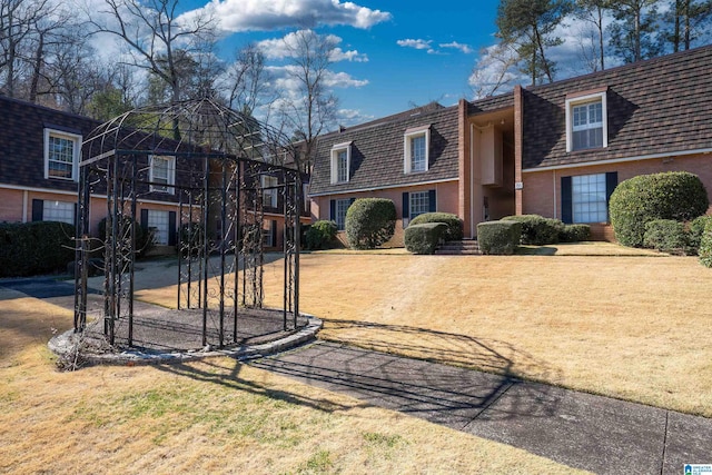 exterior space with a front lawn and brick siding