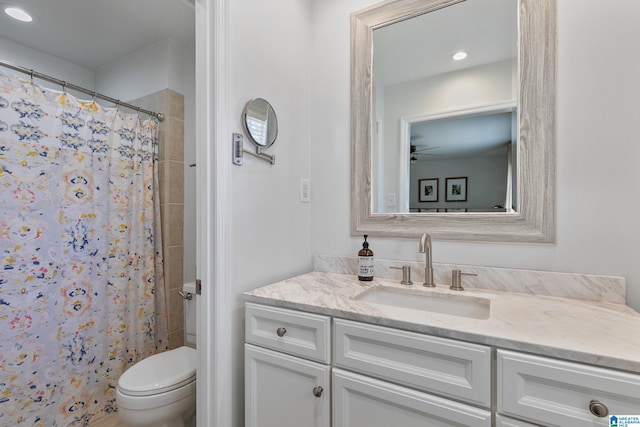 bathroom featuring toilet, a shower with curtain, and vanity