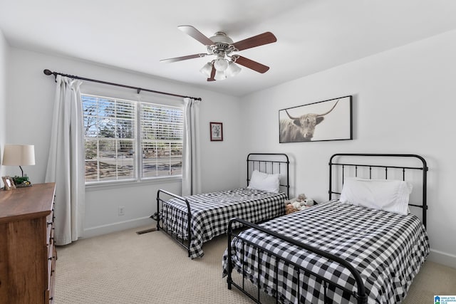 bedroom featuring light carpet, ceiling fan, and baseboards