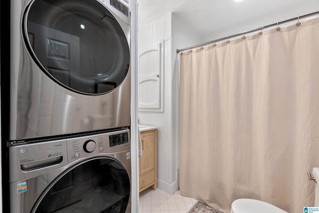 laundry area featuring laundry area and stacked washer / dryer