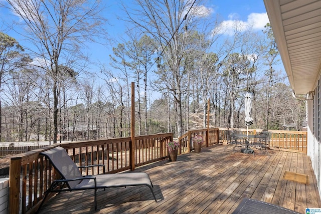 wooden deck featuring outdoor dining area