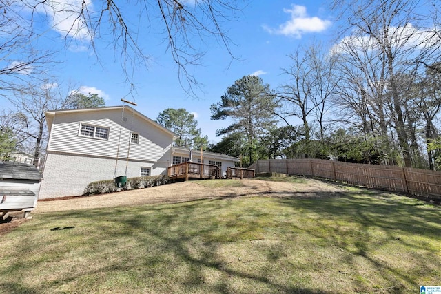 view of yard featuring fence and a deck