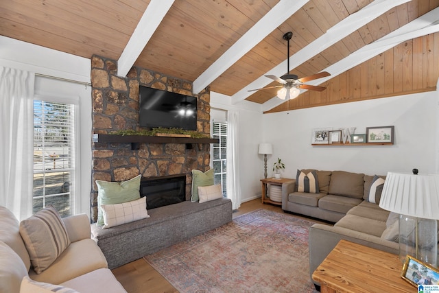 living area featuring a stone fireplace, wooden ceiling, lofted ceiling with beams, and wood finished floors