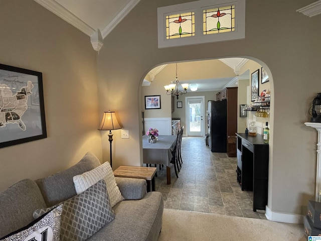 living room with baseboards, arched walkways, ornamental molding, high vaulted ceiling, and a notable chandelier