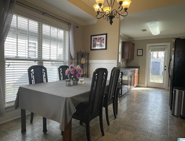 dining area with ornamental molding, a chandelier, and visible vents