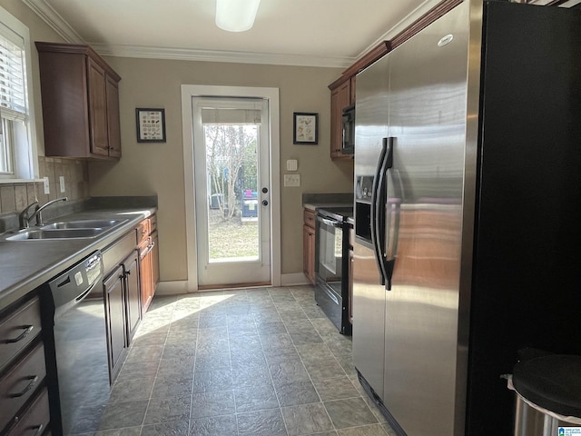 kitchen featuring baseboards, a sink, crown molding, black appliances, and backsplash