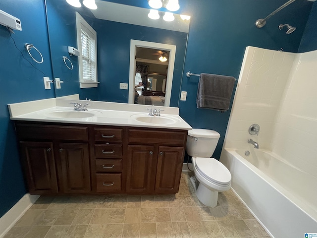 ensuite bathroom with toilet, double vanity, a sink, and ensuite bathroom