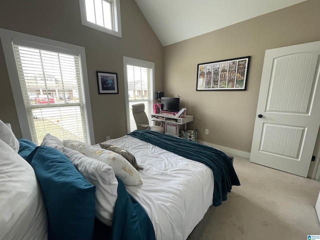 carpeted bedroom with high vaulted ceiling, multiple windows, and baseboards