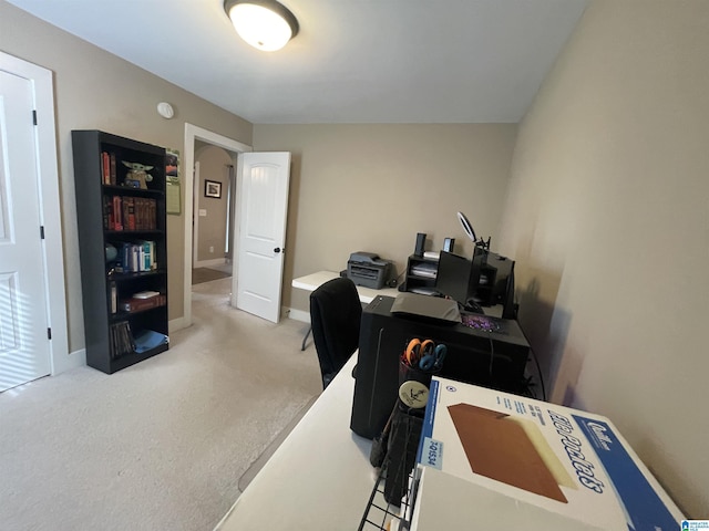 carpeted home office with baseboards