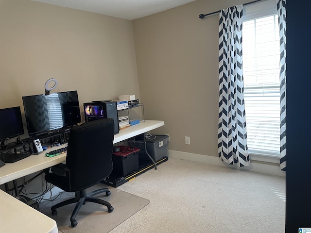 carpeted office space featuring baseboards