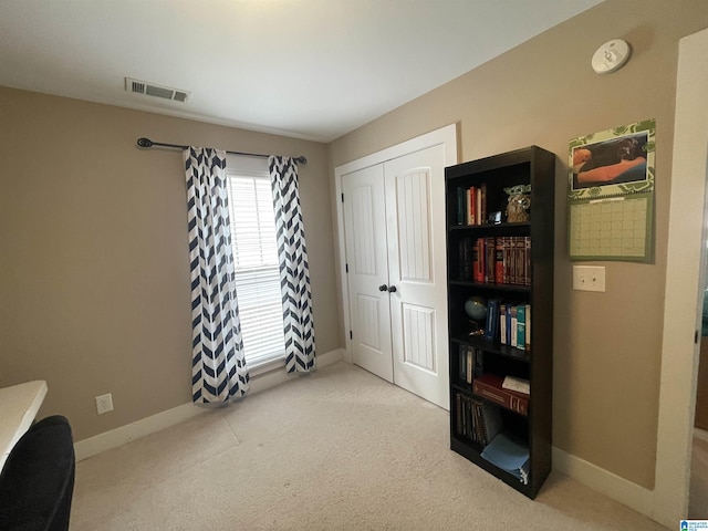 interior space with carpet, baseboards, and visible vents