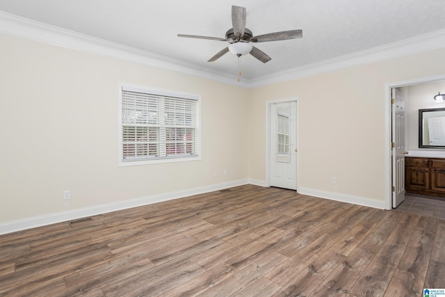 unfurnished room with baseboards, dark wood-style flooring, and crown molding