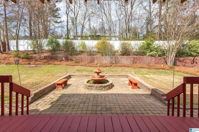 wooden deck with a yard, a patio area, a fenced backyard, and a water view