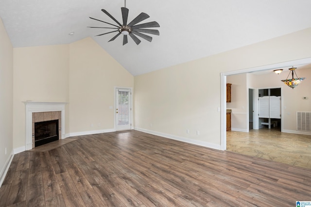 unfurnished living room featuring wood finished floors, visible vents, a fireplace, and ceiling fan