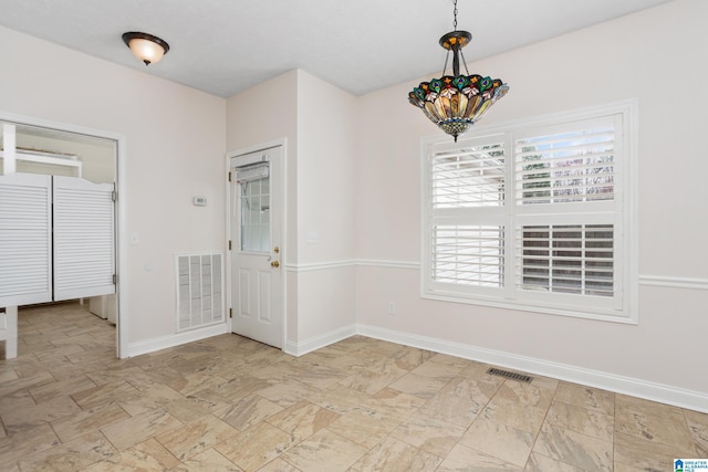 spare room with visible vents and baseboards