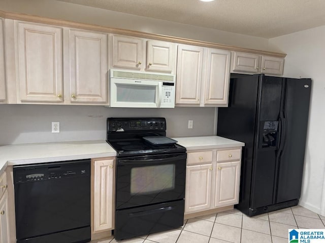 kitchen with light countertops, black appliances, and light tile patterned floors