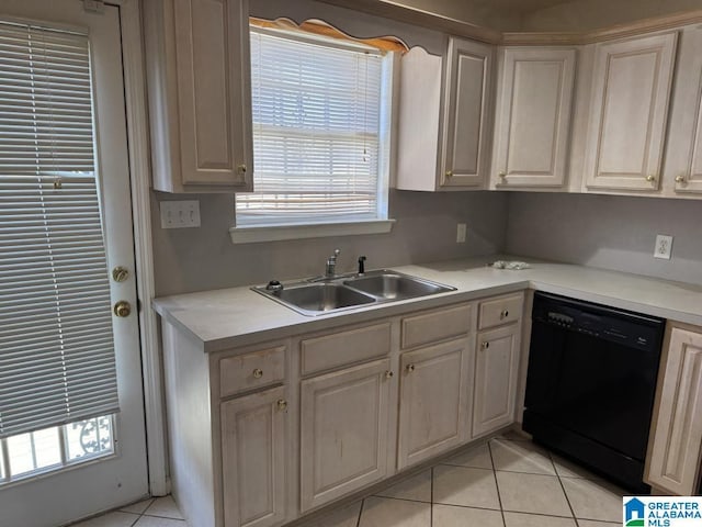 kitchen featuring dishwasher, light countertops, a sink, and light tile patterned flooring