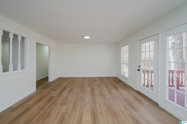 empty room with light wood-style floors and baseboards