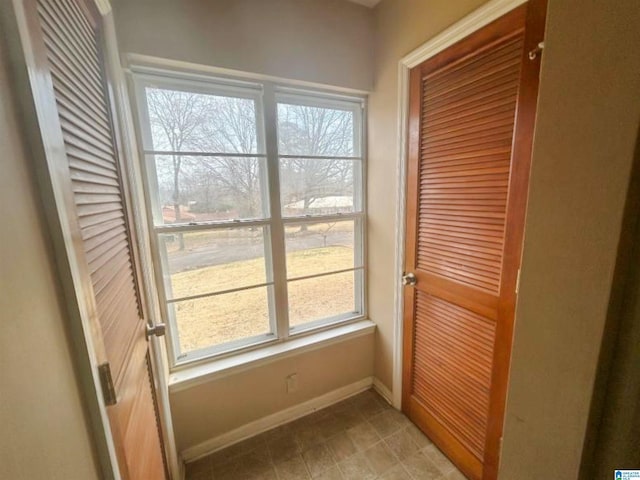 doorway featuring baseboards