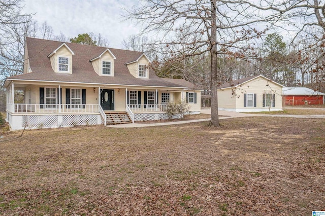 view of front of house with a porch, a front yard, and roof with shingles