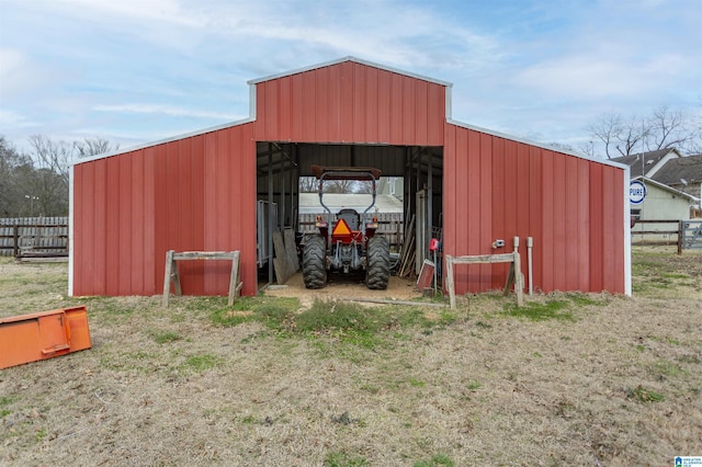 view of pole building featuring fence