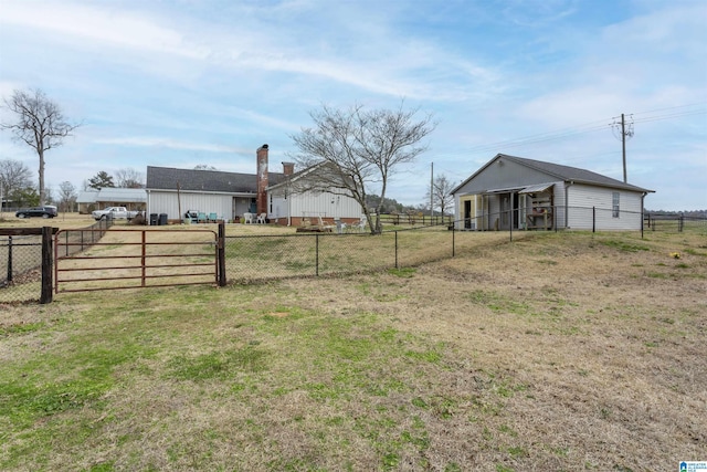 view of yard with fence and an outdoor structure