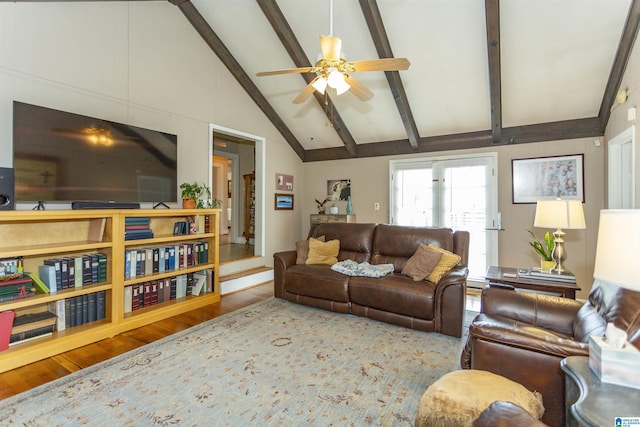 living area featuring ceiling fan, vaulted ceiling with beams, and wood finished floors