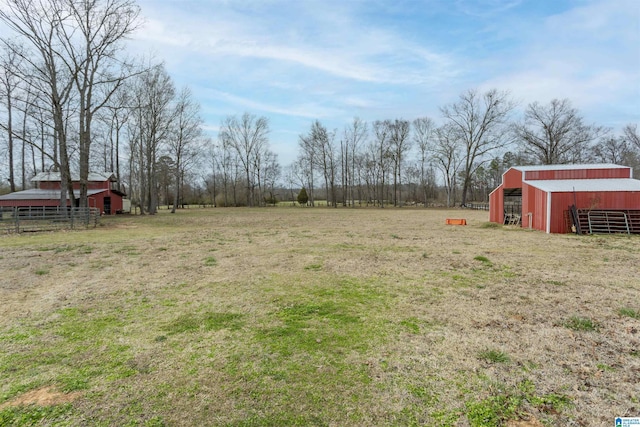 view of yard featuring an outbuilding, an outdoor structure, and fence